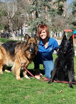 Nuria Espinosa educadora canina de LealCan posa junto a sus dos perros en un parque